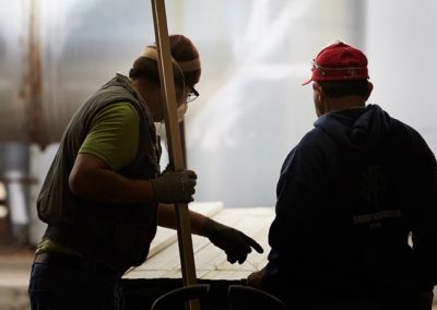 Skilled workers inspect custom millwork order.